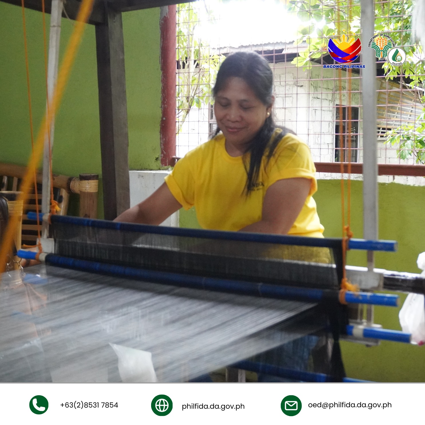 A woman happily weaving a pineapple fabric cloth